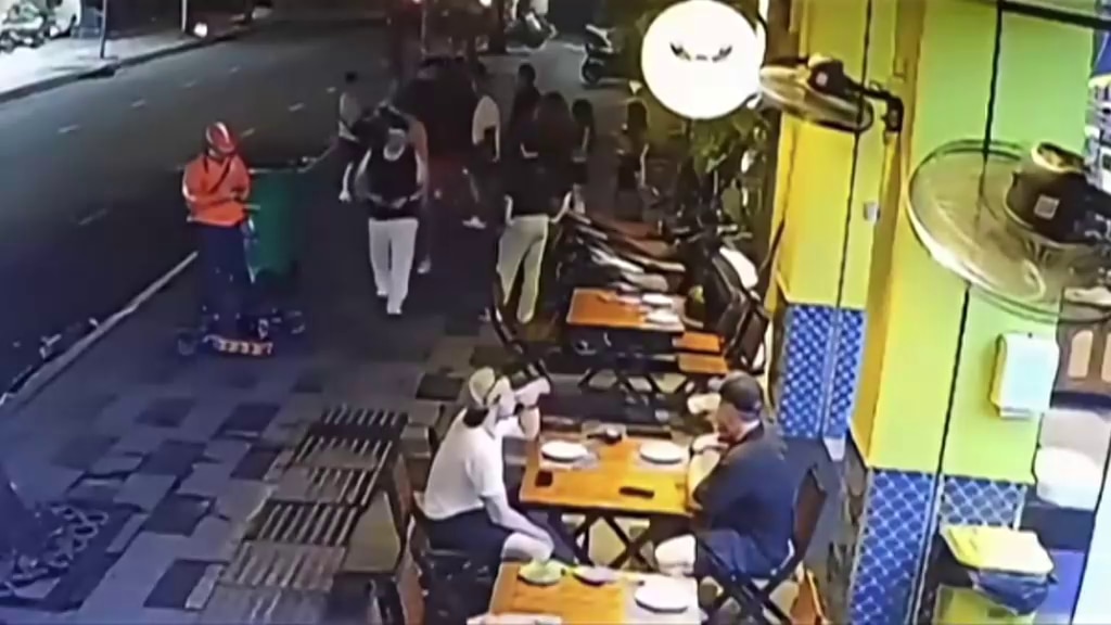 CCTV vision of a road with restaurants and pedestrians in Vietnam. 