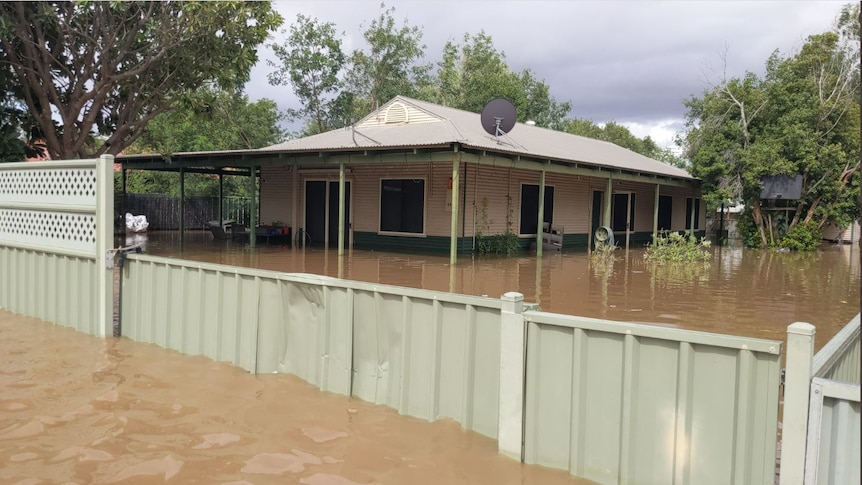 Image of flood waters filling the front yard of a home in Fitzroy Crossing.
