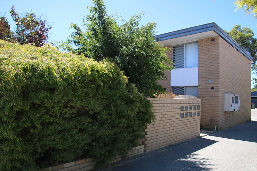 A 1960's style two storey apartment block viewed from the side.