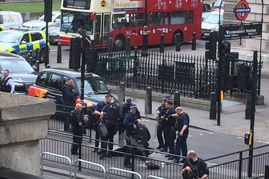 Police arrest a man on the pavement in Whitehall.