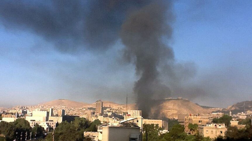 Black smoke can be seen rising from the area of the blast.
