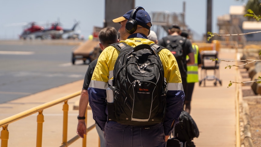 Fly-in fly-out workers walking on the tarmac at Karratha airport in north-west Western Australia.
