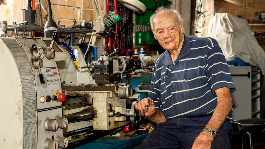 Charlie Boase sits at a lathe 