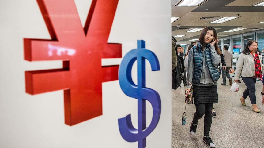 A sign with the symbols for the Chinese Yuan (left) and the US Dollar in Hong Kong