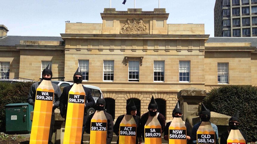 Australian Education Union members dress as pencils in a protest outside the Tasmanian Parliament.