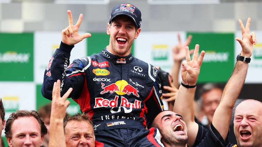 Best there is ... Red Bull's Sebastian Vettel celebrates with team-mates after securing a third-straight world title.