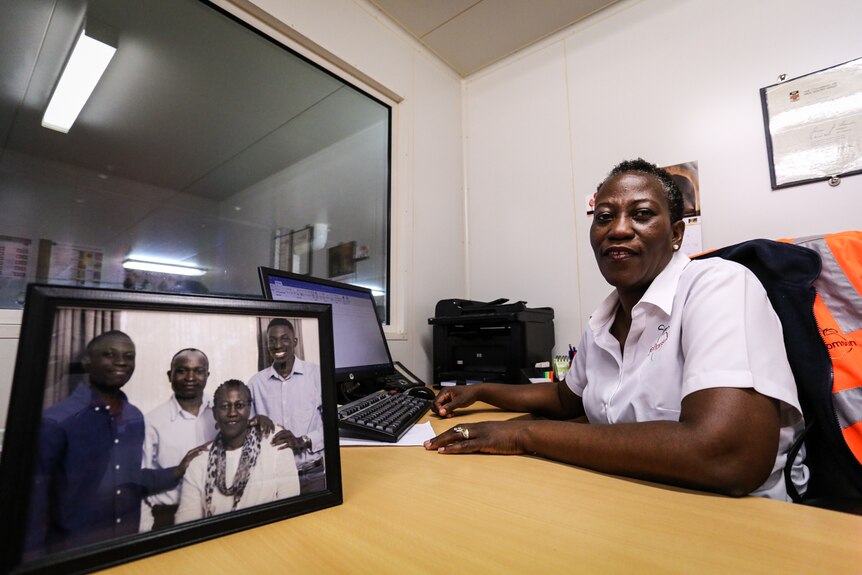 Oladele in her office with a picture of her family in the foreground.