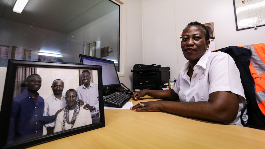 Oladele in her office with a picture of her family in the foreground.