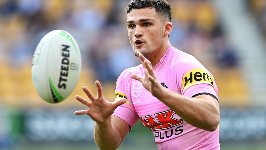 Nathan Cleary prepares to catch a ball with his mouth open