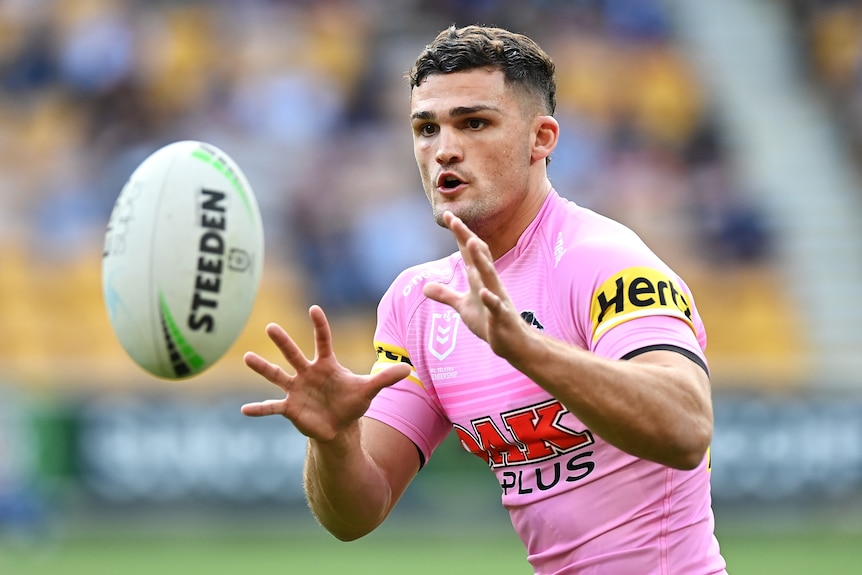Nathan Cleary prepares to catch a ball with his mouth open