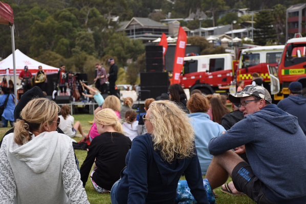People gather at a relief concert in Lorne