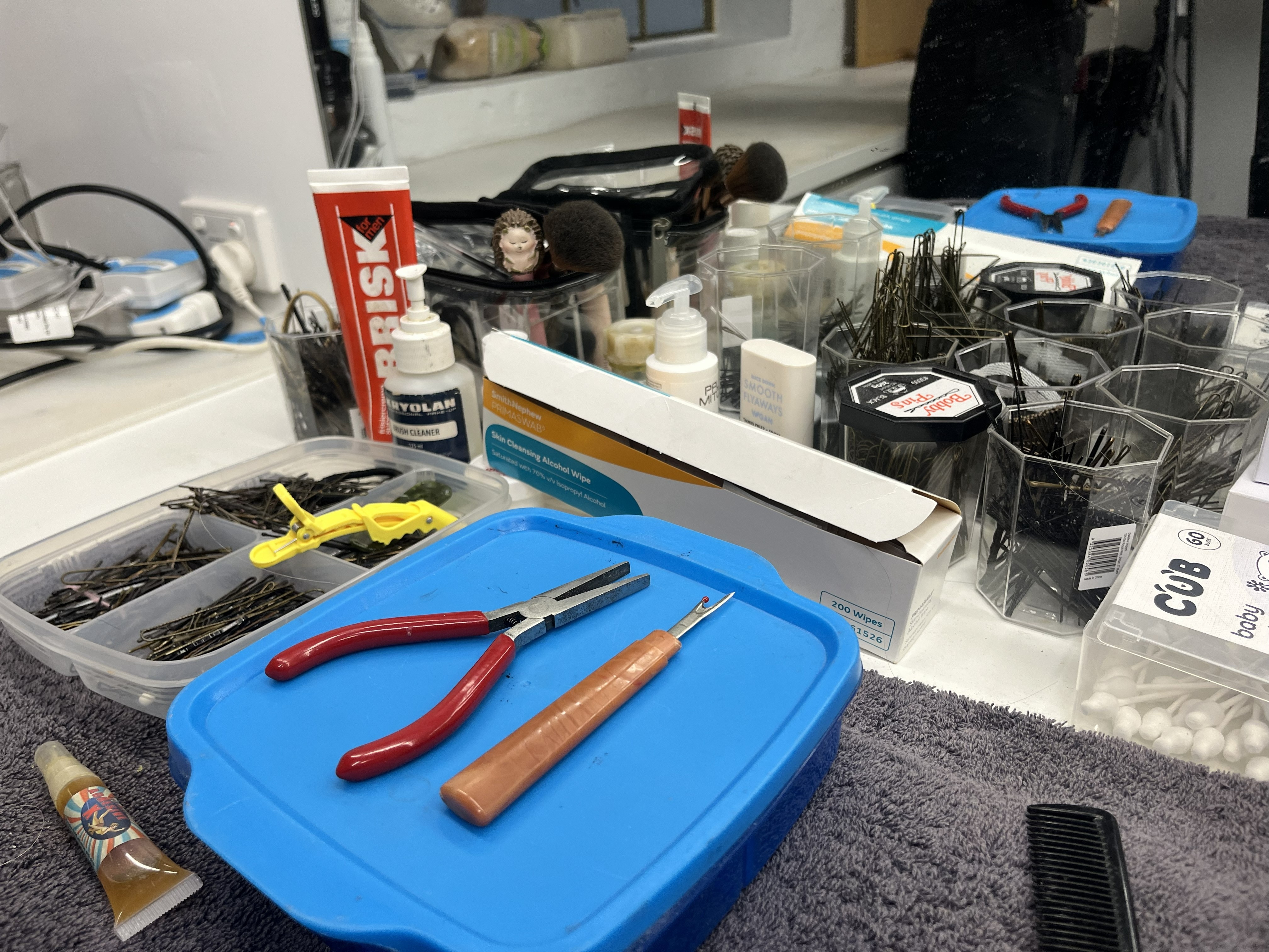 Tools including pliers on a workbench.