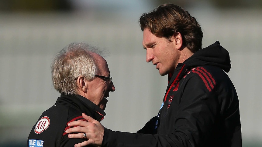 Essendon doctor Bruce Reid and coach James Hird in discussion during a Bombers training session