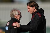 Essendon doctor Bruce Reid and coach James Hird in discussion during a Bombers training session