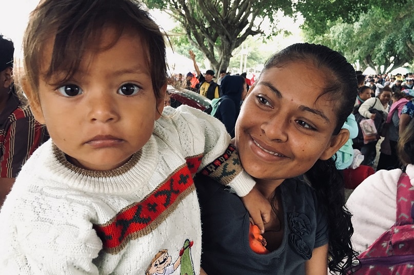 A mother and her child are among those on the migrant caravan from El Salvador.