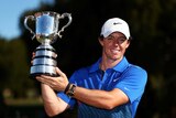 To the victor the spoils ... Rory McIlroy holds aloft the Stonehaven Cup