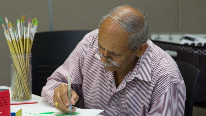 A man painting at a table