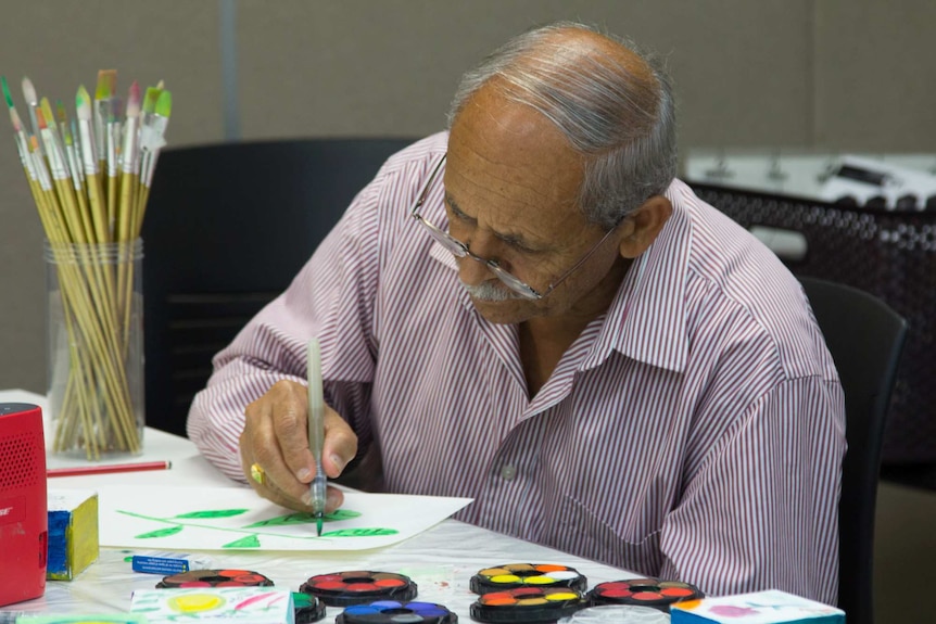 A man painting at a table