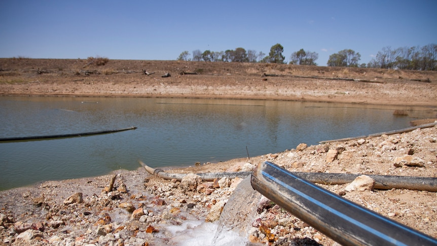 Water flowing from a pipe into a dam on Wambo Feedlot, west of Dalby in October 2019.