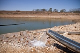 Water flowing from a pipe into a dam on Wambo Feedlot, west of Dalby in October 2019.