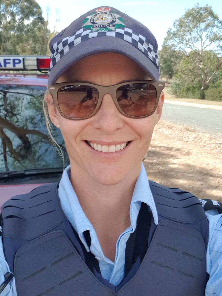 Claire O'Neill smiles in her police uniform.