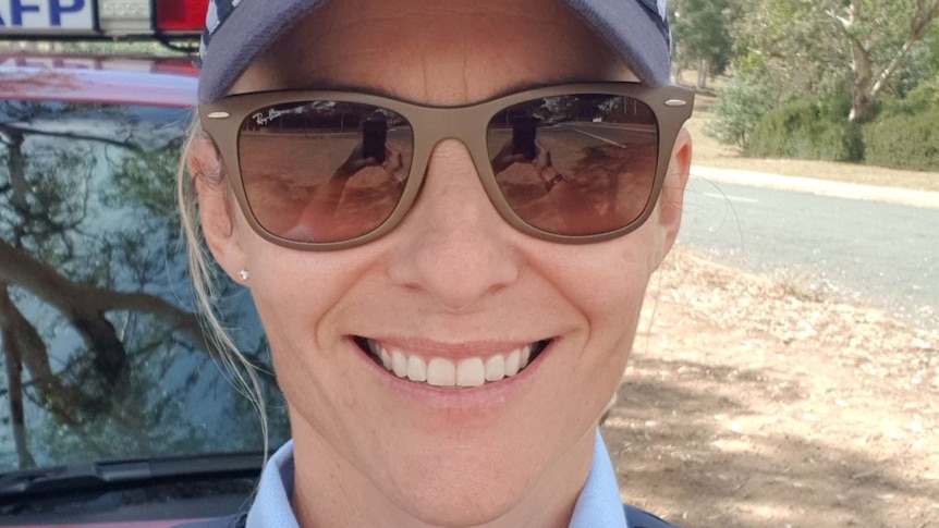 Claire O'Neill smiles in her police uniform.