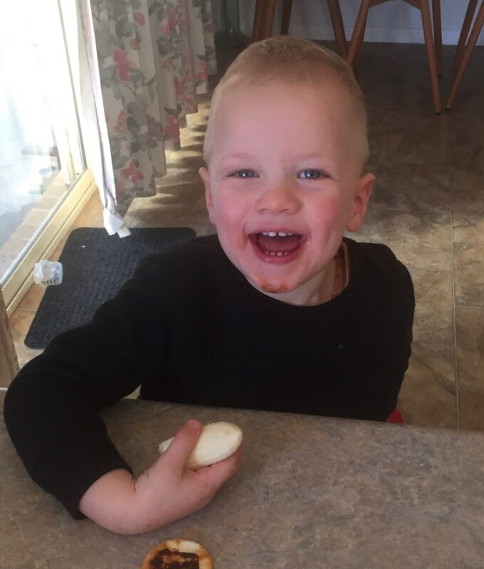 Cute toddler, eating and smiling 