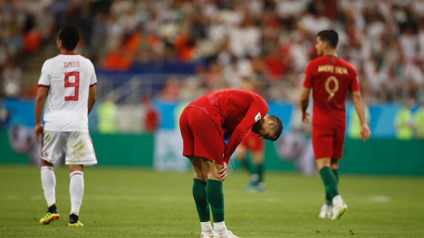 Cristiano Ronaldo holds his hands to his knees