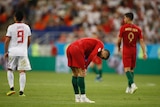 Cristiano Ronaldo holds his hands to his knees