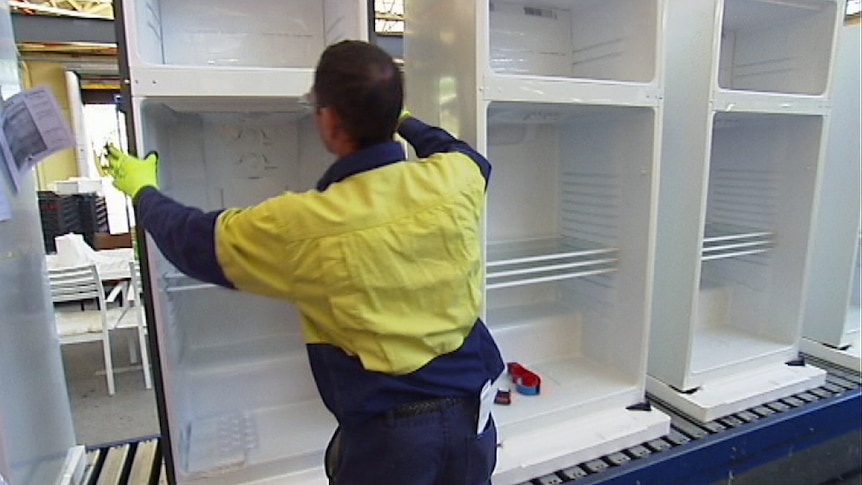 Worker at Electrolux fridge factory in Orange