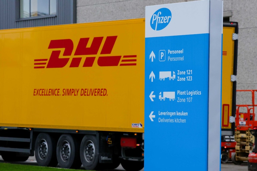 A yellow and red DHL truck is seen at a Pfizer facility.