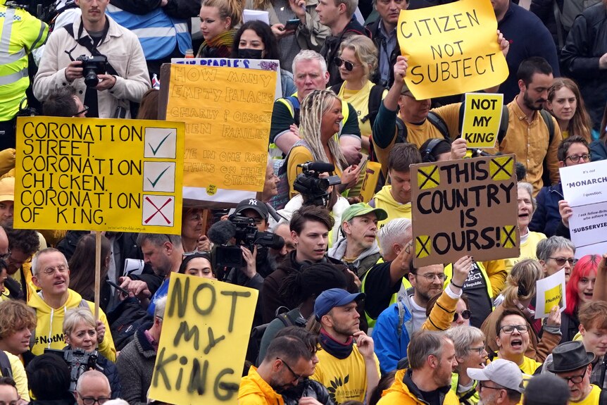 Protesters hold yellow 'not my king' signs in Trafalgar Square ahead of King Charles's coronation.