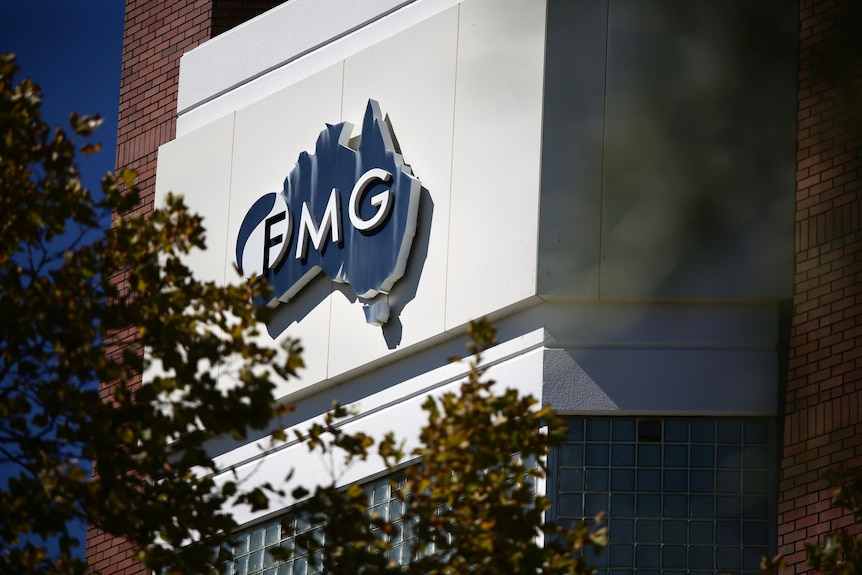 A blue and white sign with the initials 'FMG' on it. 