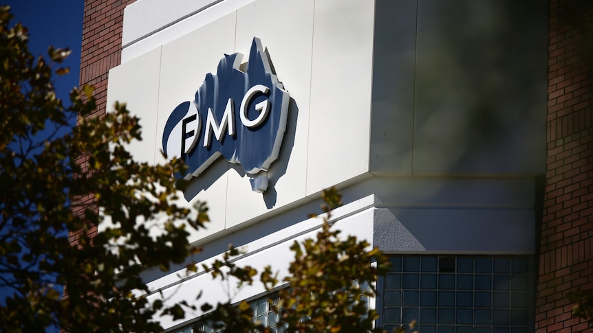 Image of a blue sign on a white building bearing the FMG logo.