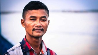 A Cambodian man looks at the camera.