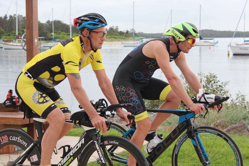 Two men cycling.