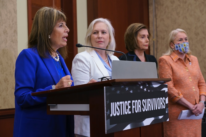 Four Democratic women stand side by side at a press conference
