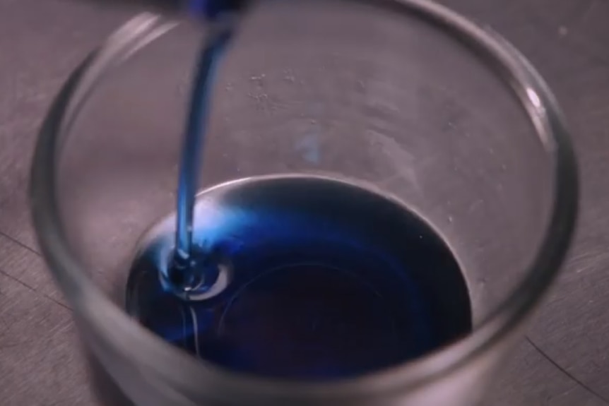 Blue oil being poured.