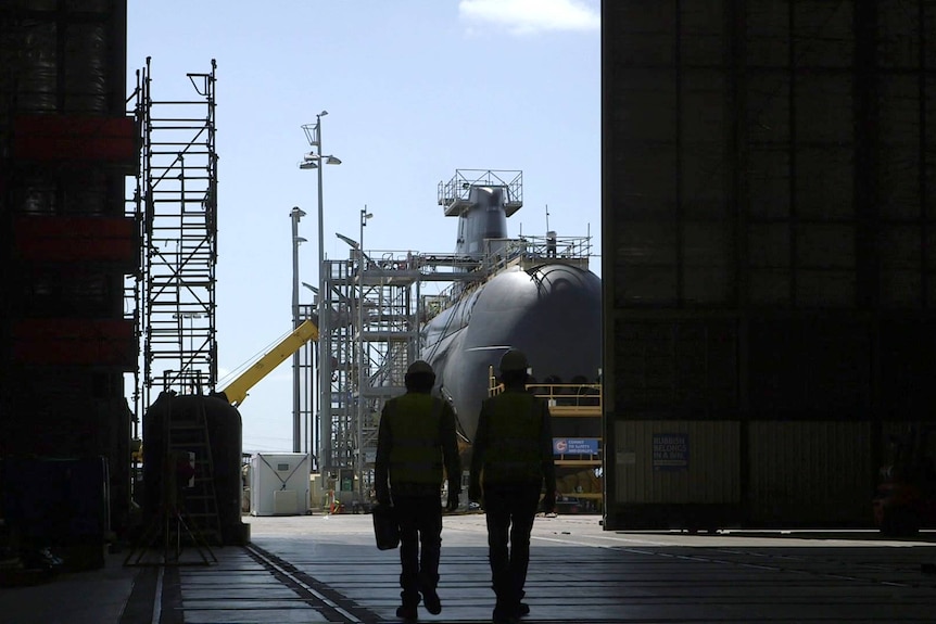 Workers near a Collins-class submarine at the ASC shipyard.