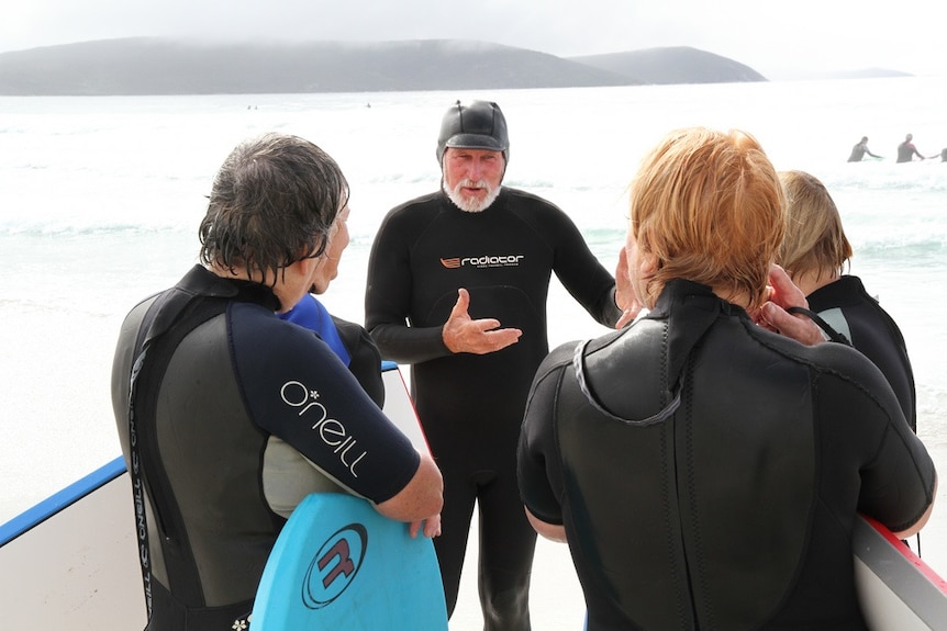 Tony Harrison in a wet suit and some "Granny Grommets" about to hit the surf