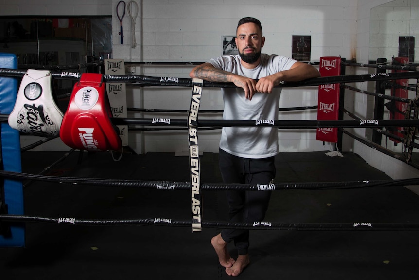 Boxer and gym owner Jacob Najjar stands in boxing ring.