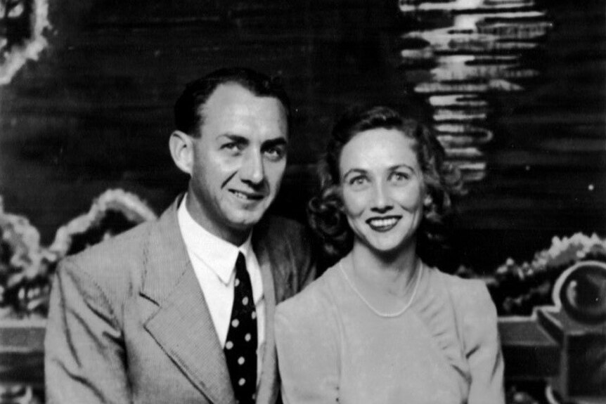 a black and white photo of a man and a woman smiling