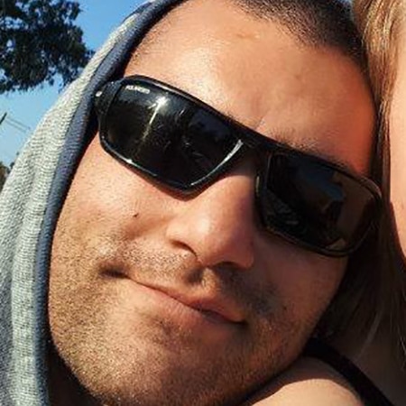 A tight head shot selfie of a man wearing sunglasses and a hood on his head.