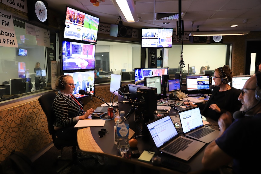 Two women and one man in radio studio.