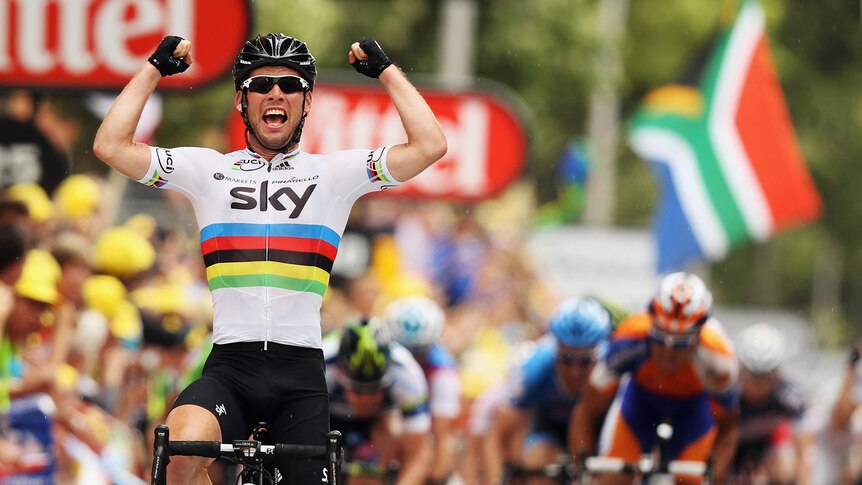 Win number 22... Mark Cavendish salutes as he crosses the finish line.