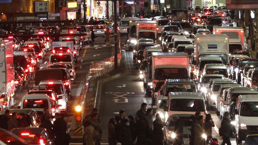 Traffic is in chaos as people are forced to walk home between gridlocked vehicles in central Tokyo