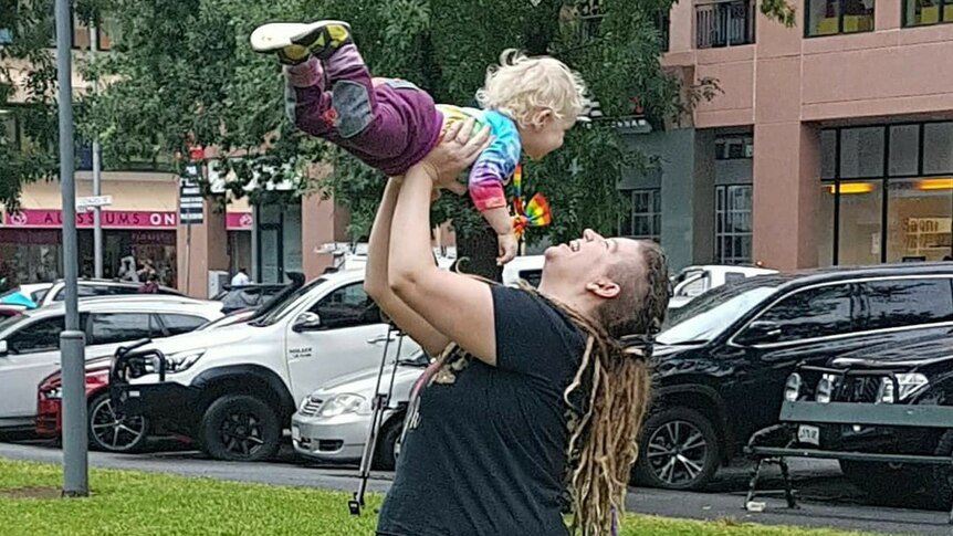 Ms Reece holds her daughter in a park