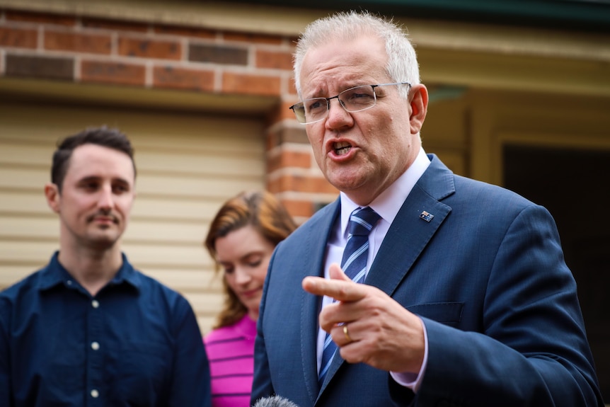 Scott Morrison points while speaking at a press conference 