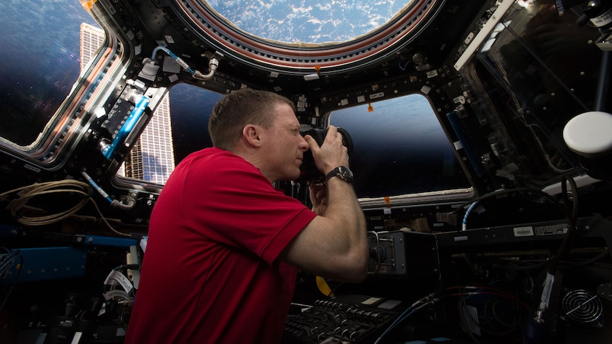 A NASA astronaut takes a photo inside the Space Station's Cupola module