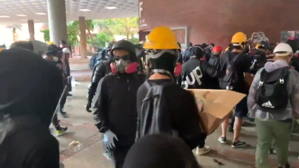 PolyU students prepare themselves for riot police as they attempt to ...